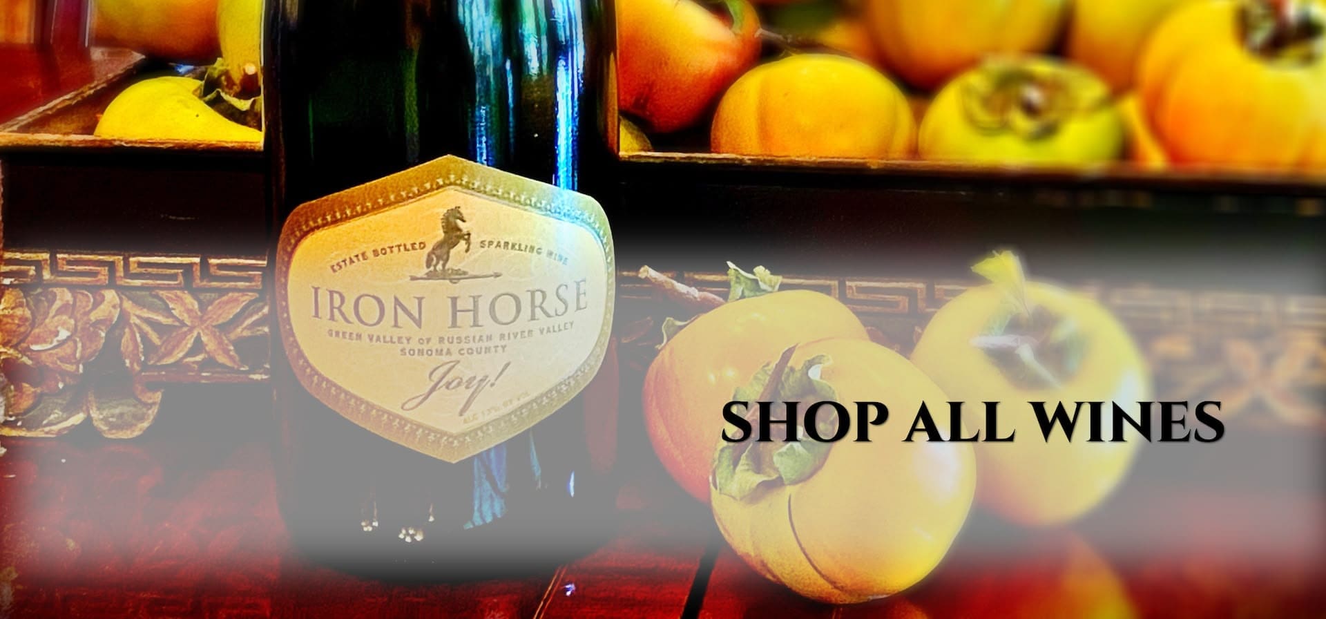 Bottle of Iron Horse wine beside fresh persimmons, with the text SHOP ALL WINES on the image.