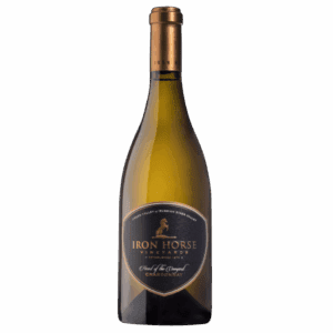 A bottle of Iron Horse Vineyards Chardonnay wine with a gold foil top on a plain background.