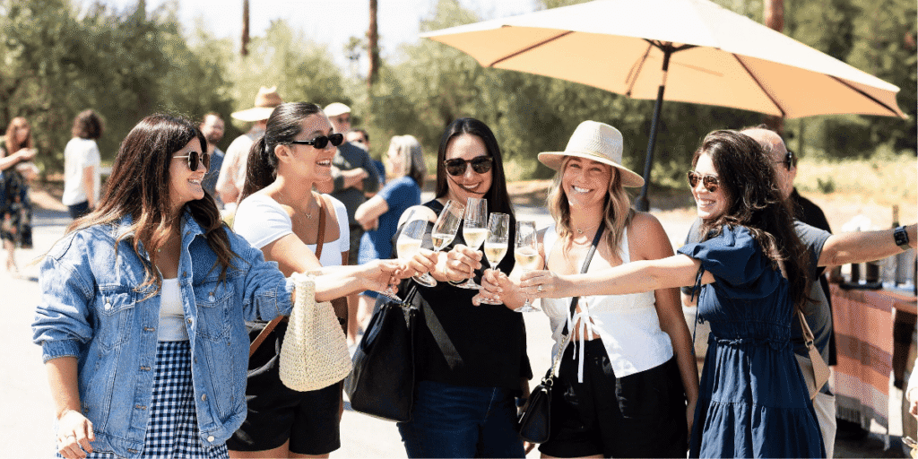 A group of women toasting with a glass of champagne at Iron Horse Winery
