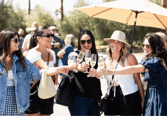 A group of women toasting with a glass of champagne at Iron Horse Winery