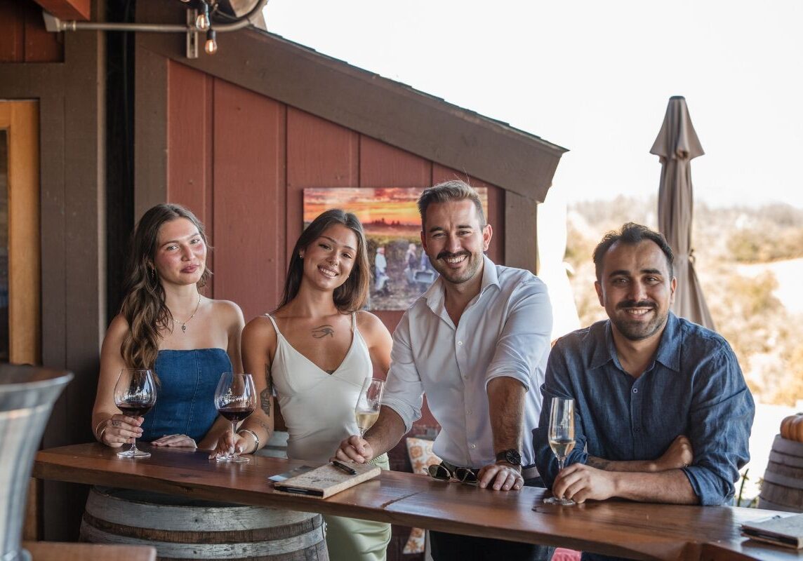 people standing at the iron horse vineyards tasting bar